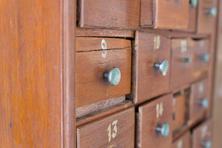 wooden drawer of old cabinet with number