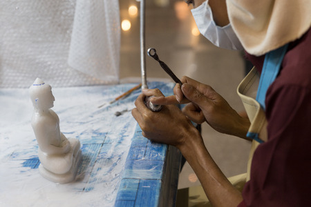 Chiang Mai, Thailand - September 18, 2016:  artisan carve and sculpture buddha image statue in unseen lanna expo 2016 held at Chiang Mai International Exhibition and Convention Centre in Chiang Mai, Thailand on September 18, 2016.のeditorial素材
