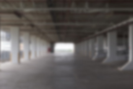 empty indoor car parking lot in building - blur for background