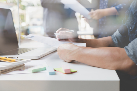 people working with document and laptop computer meeting in office workplace - blur for backgroundの写真素材