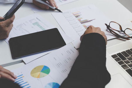 businessman working with document, smartphone and digital tablet in office workplace - blur for backgroundの写真素材