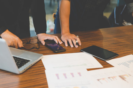 people working with document, tablet and smartphone - meeting in office workplace concept