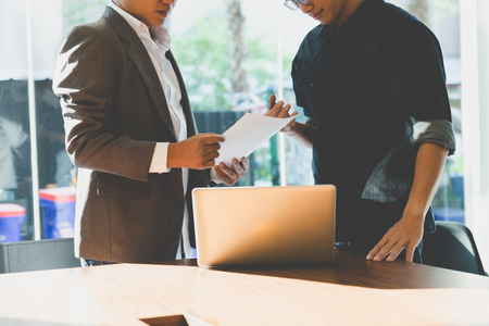 people working with document and laptop computer - meeting in office workplace conceptの写真素材