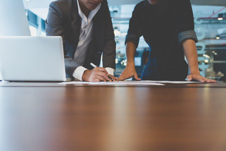 people working with document and laptop computer - meeting in office workplace concept