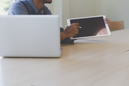 photographer retouching photo, graphic designer drawing image using a digital tablet, pen and...