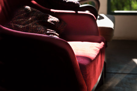 red chair in living room near window with garden viewの写真素材
