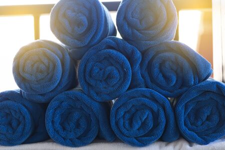 pile of rolled folded blue towel in spa resortの写真素材