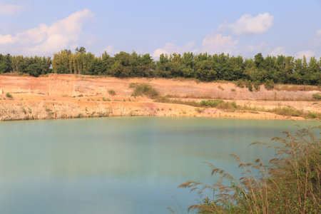 landscape view of orange valley hill and green water pond lake