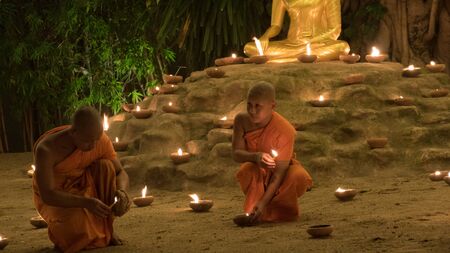 Chiang Mai, Thailand - November 14, 2016: buddhist monk light candle in Yeepeng festival at Puntao temple in Chiang Mai, Thailand on November 14, 2016.のeditorial素材