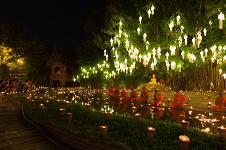 Chiang Mai, Thailand - November 14, 2016: buddhist monk pray at buddha statue in Yeepeng festival at Puntao temple in Chiang Mai, Thailand on November 14, 2016.のeditorial素材