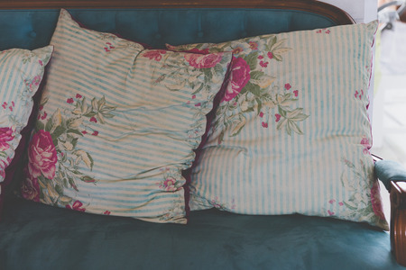 blue and pink pillow on blue old style retro vintage sofa couchの写真素材