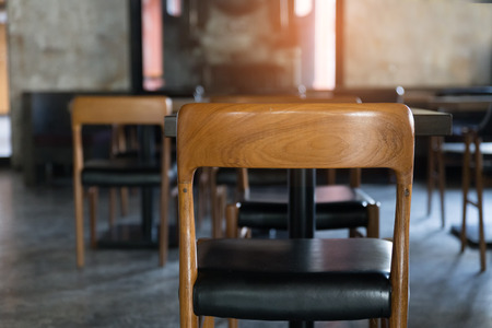 wood chair with black leather cushion and table in cafe restaurantの写真素材