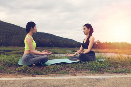 young girl meditates while practicing yoga. freedom, calmness and relax concept, woman happinessの写真素材