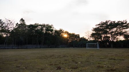 soccer Football gate in field at sunrise, sunsetの写真素材