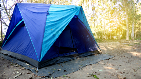 blue tent camping in forest, outdoor travel conceptの写真素材