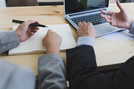 Businessman And Businesswoman discuss information project at meeting In Modern Officeの写真素材