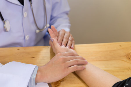doctor measuring pulse of his senior patient. healthcare and medical conceptの写真素材
