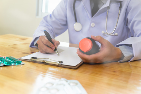 Doctor working in hospital writing RX prescription, Healthcare and medical concept, medicine, stethoscope with clipboard, selective focusの写真素材