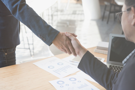 two businessman handshaking for successful deal after negotiation in meeting. business partnership corporate concept.の写真素材