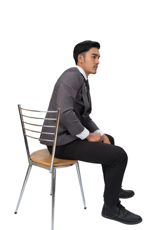 young asian handsome male startup entrepreneur Businessman wearing gray suit sitting on chair and thinking over white Backgroundの写真素材