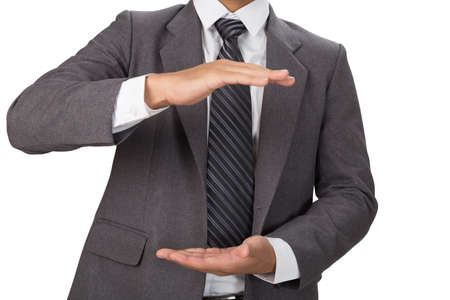 businessman in casual gray suit gesturing with hands on a white backgroundの写真素材
