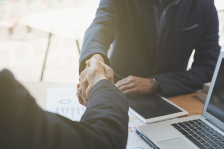 two businessman handshaking for successful deal after negotiation in meeting. business partnership corporate concept.の写真素材