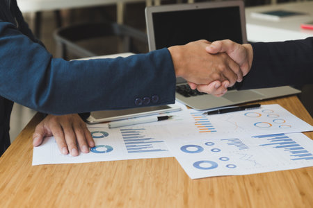 two businessman handshaking for successful deal after negotiation in meeting. business partnership corporate concept.の写真素材