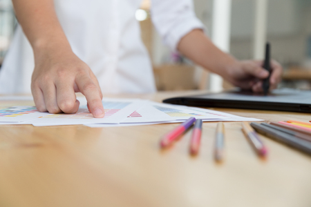 freelance artist graphic designer drawing on digital tablet. young woman working with color swatch palette catalog samples for selection - Creativity Editor Ideas Conceptの写真素材