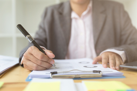 Business woman analyzing income charts and graphs in office. Business analysis and strategy concept.の写真素材