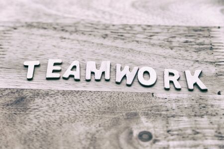 Word teamwork from wood letters on wooden table - business conceptの写真素材