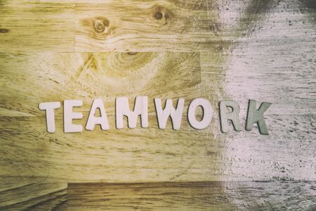 Word teamwork from wood letters on wooden table - business conceptの写真素材