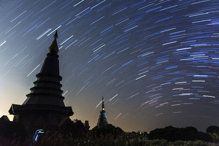 Night sky with star trail and two pagoda in Doi Inthanon mountain, natural astronomy landscape  (The...