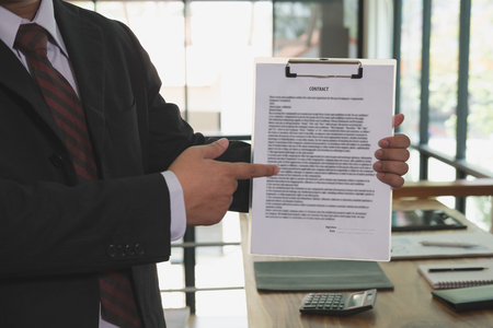 Businessman pointing the sign contract agreement document, business conceptの写真素材
