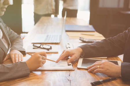Businesswoman working with businessman. two business people discussing document and idea at meeting....