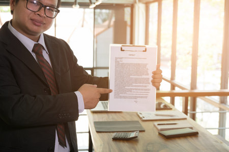 Businessman pointing the sign contract agreement document, business conceptの写真素材