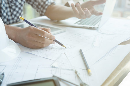 young architect working on real estate project at workplace. Male engineer hand working with living...