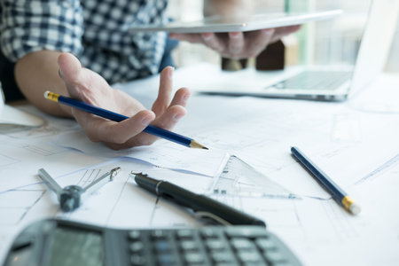 young architect working on real estate project at workplace. Male engineer hand working with digital...