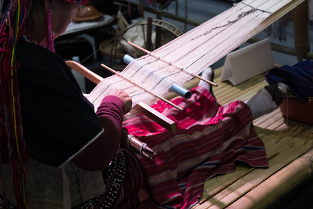 Chiang Mai, Thailand - July 1, 2017:  old woman weave traditional Thai fabric textile at Lanna Expo 2017 in Chiang Mai, Thailand on July 1, 2017.のeditorial素材