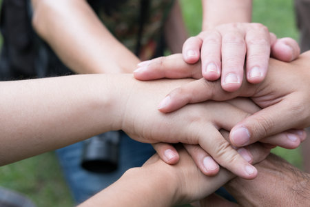 young college student joining united hand, start up business team touching hands together - unity,...