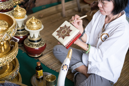 Chiang Mai, Thailand - July 1, 2017: craftsman painting gold color on souvenir gift box at Lanna Expo 2017 in Chiang Mai, Thailand on July 1, 2017.のeditorial素材