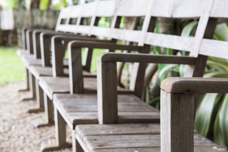 row of old wood chair in garden. furniture in the parkの写真素材