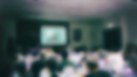 people listen to presentation in conference hall. audience in meeting room. participant sitting in lecture hall in university workshop. blur image for backgroundの写真素材