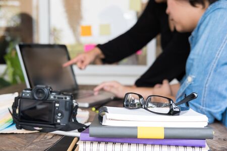 graphic designer working with computer at workplace. artist discussing design and idea at office. business people brainstorming for new creativity project. teamwork, partnership conceptの写真素材