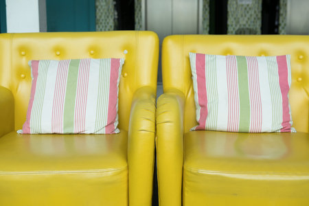 yellow leather armchair with fabric pillow in living roomの写真素材