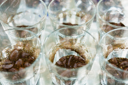 glass of coffee for taster to smell and taste aromatic and flavor wheel. art of aroma perception in brewed coffee double exposure with roasted bean. cupping examination.の写真素材