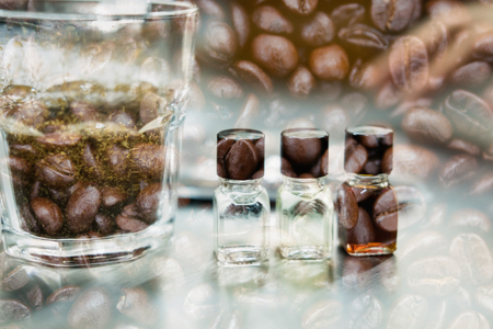 glass of coffee for taster to smell and taste aromatic and flavor wheel. art of aroma perception in brewed coffee double exposure with roasted bean. cupping examination.の写真素材