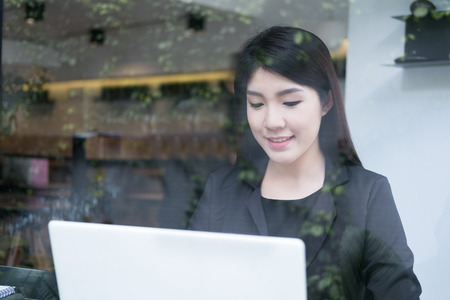 young businesswoman work with laptop at office. business person use computer at workplace. woman freelancer do her job at cafe coffee shop.の写真素材