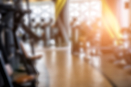 fitness facility center, gym interior, health club with sports training equipment for aerobic exercise workout and bodybuilding, blurry defocused backgroundの写真素材