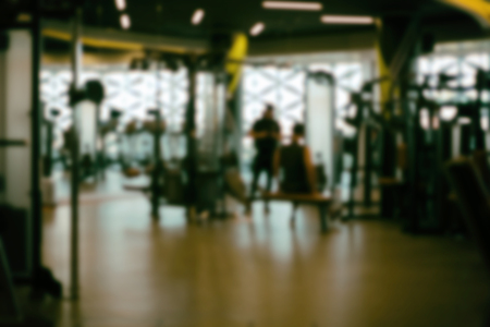 fitness facility center, gym interior, health club with sports training equipment for aerobic exercise workout and bodybuilding, blurry defocused backgroundの写真素材