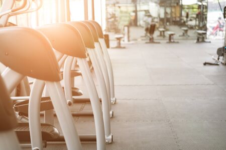 fitness facility center, gym interior, health club with sports training equipment for aerobic exercise workout and bodybuildingの写真素材
